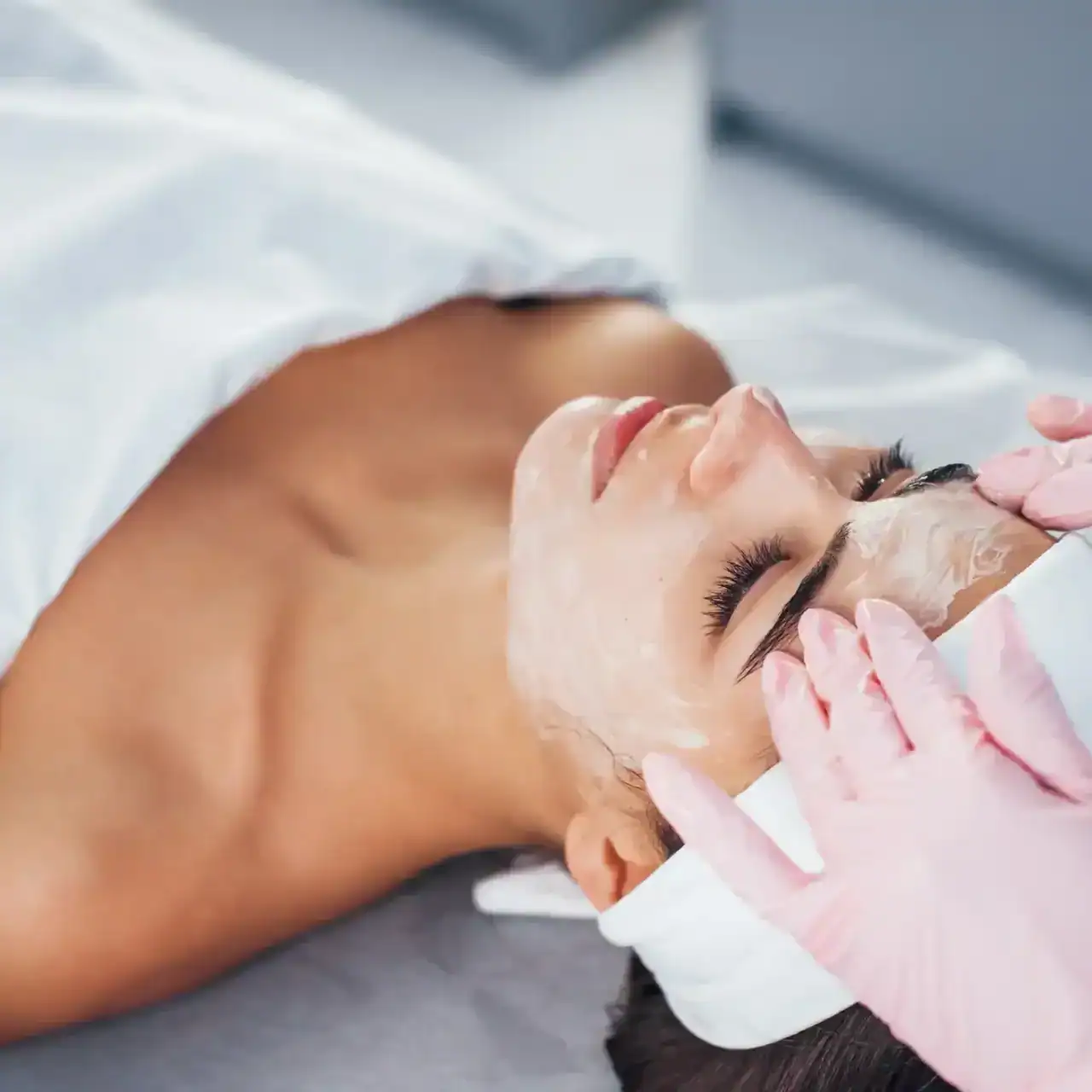 Younger woman getting a facial cosmetic treatment