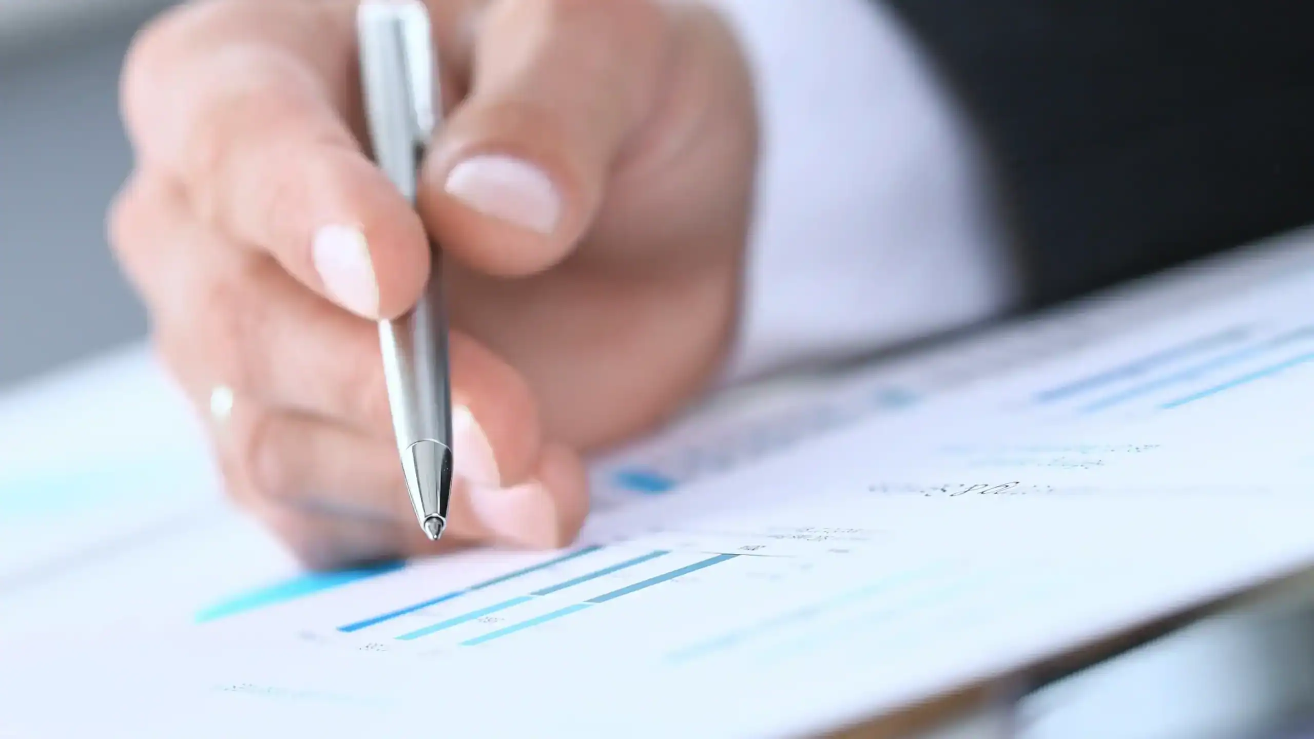 hand of a man filling out paperwork