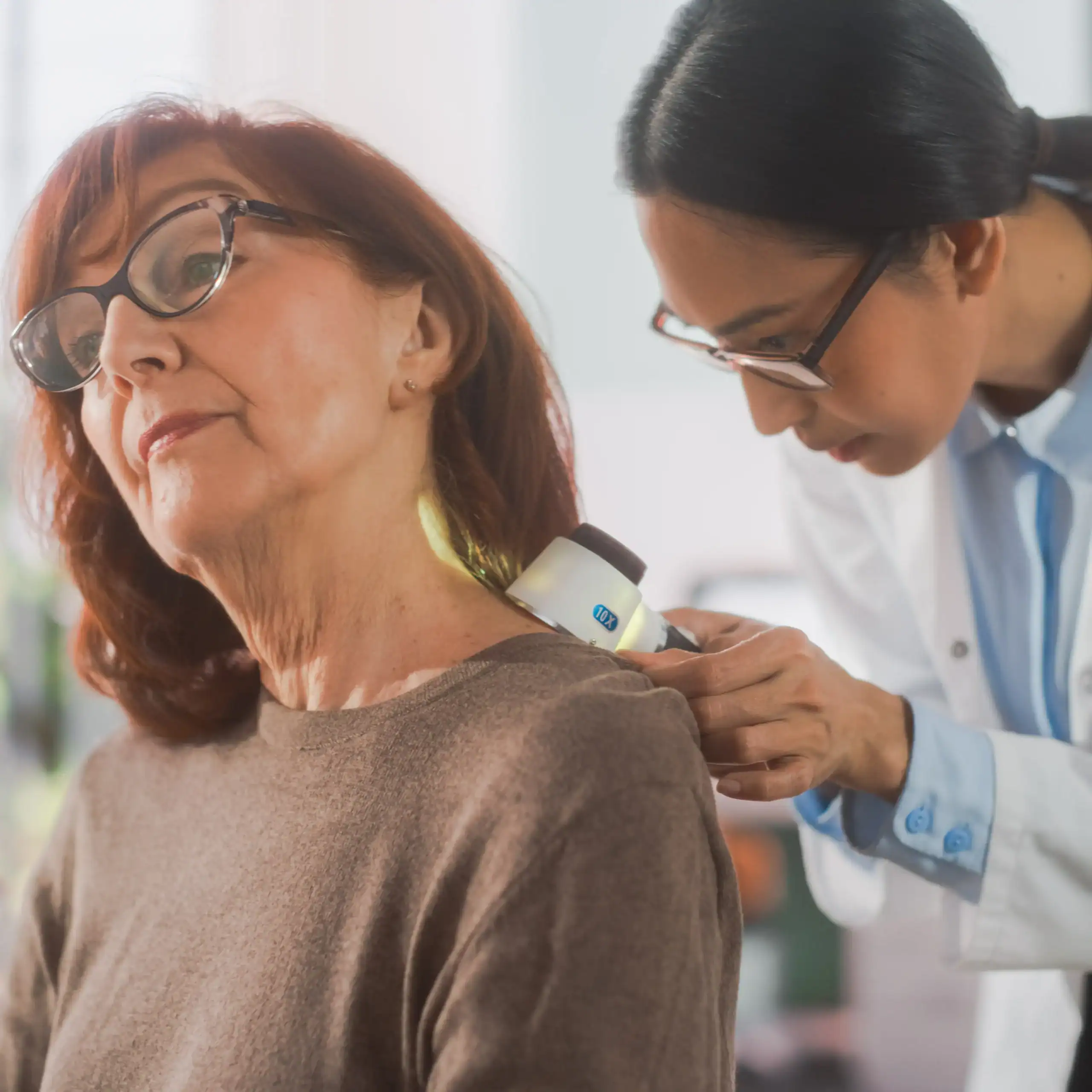 Dermatologist examining a patient's skin