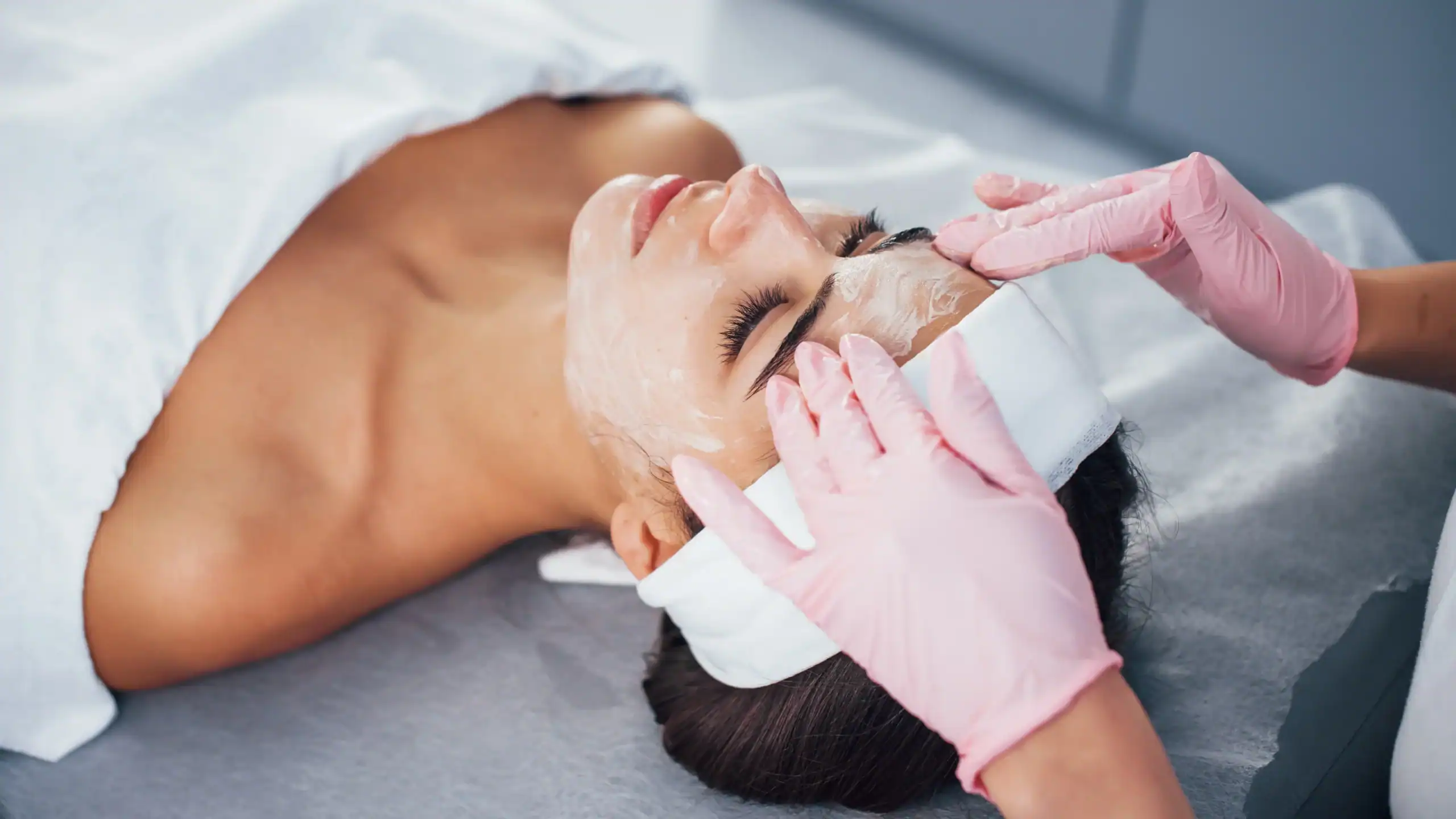 Woman getting an aesthetic treatment at a dermatology spa