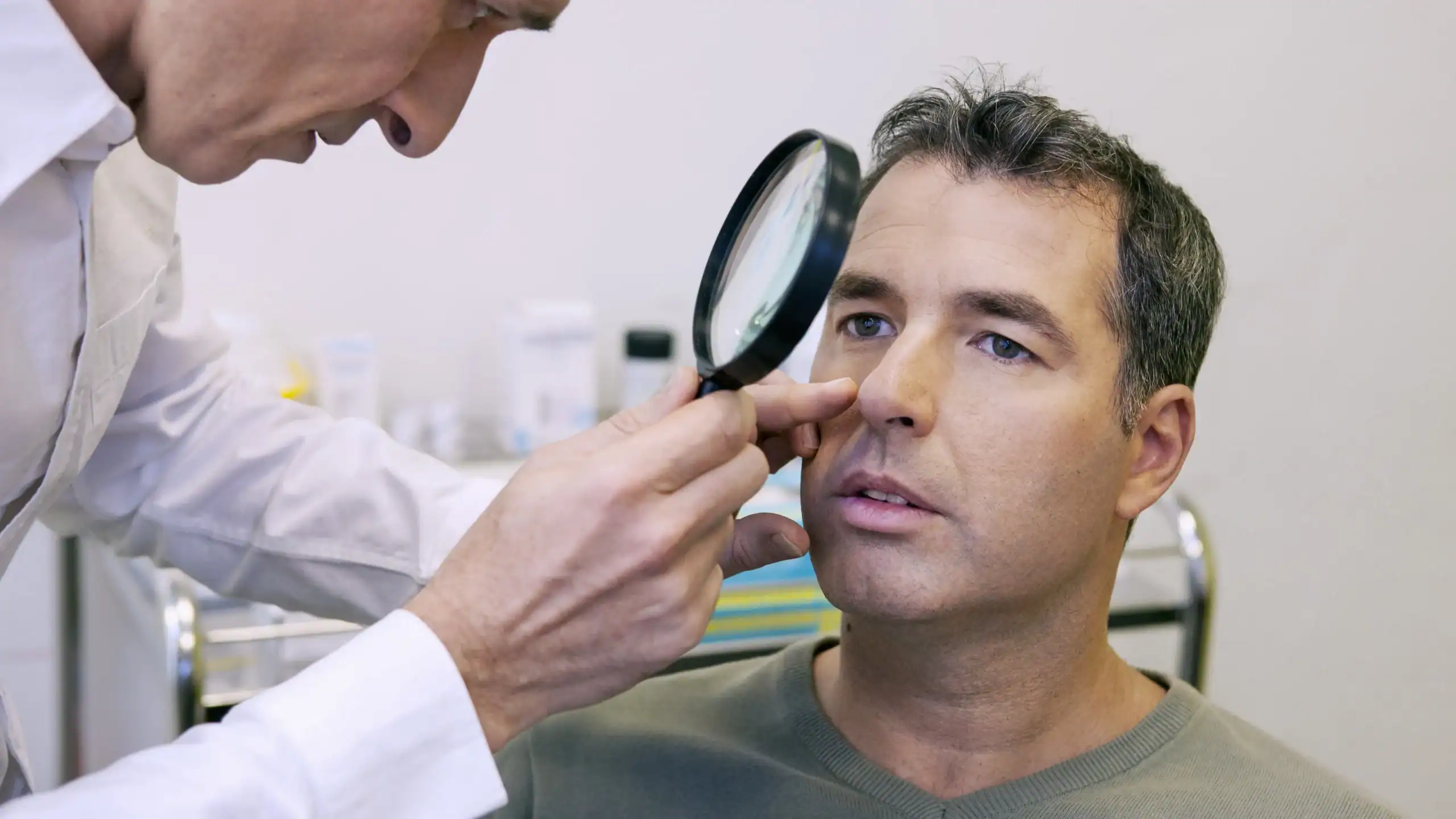 Man at a medical dermatology appointment with his dermatologist