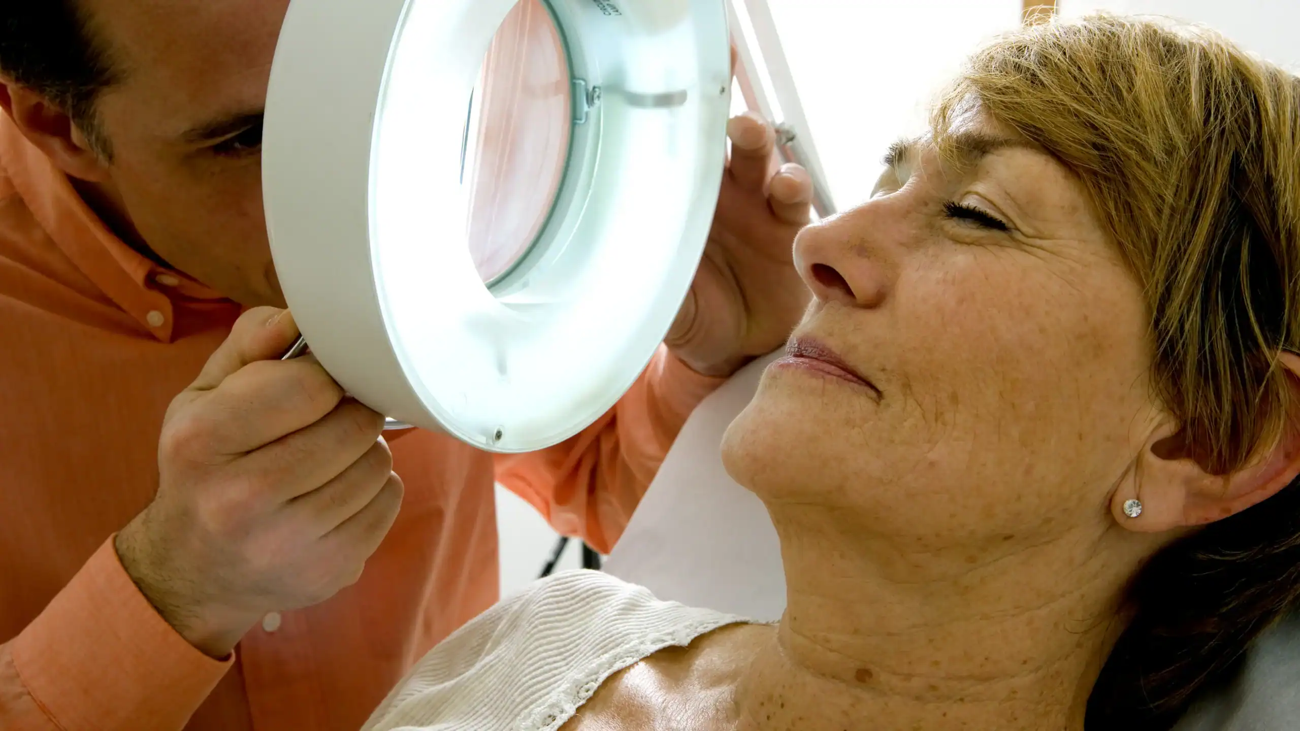 Woman getting a skin cancer examination at a dermatologist